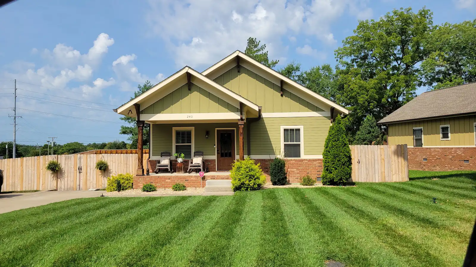 Green bungalow with a covered porch in Old Hickory, Tennessee.